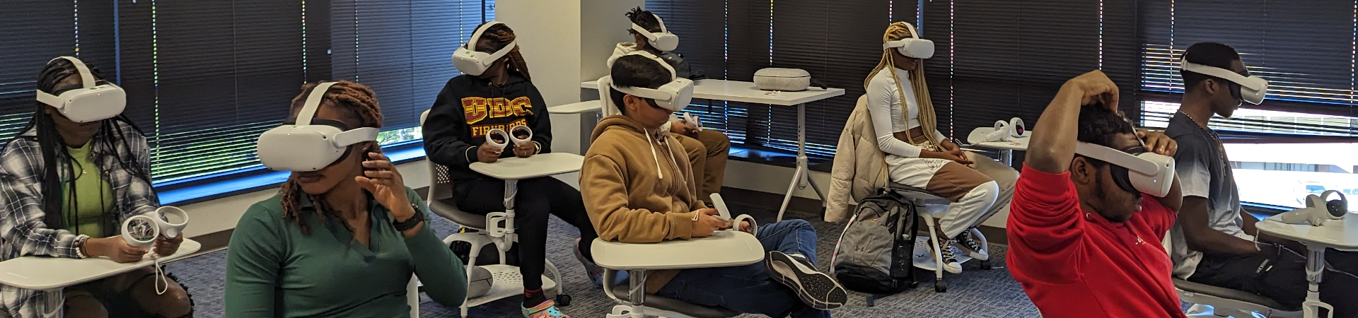 Many students in a classroom all wearing virtual reality headsets