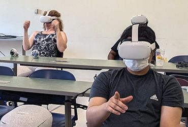 Two people in VR headsets in the UDC VR lab