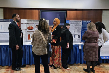 A group of students in front of a presentation