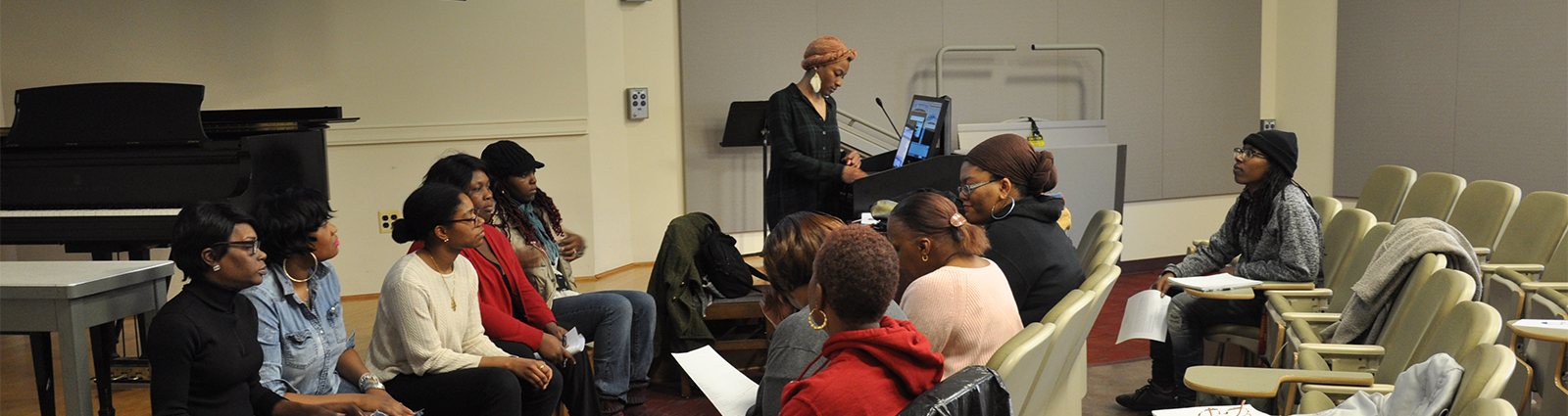 speaker speaking to a group of students