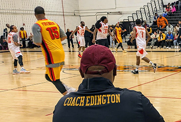 Coach Edington watching the alumni basketball game.