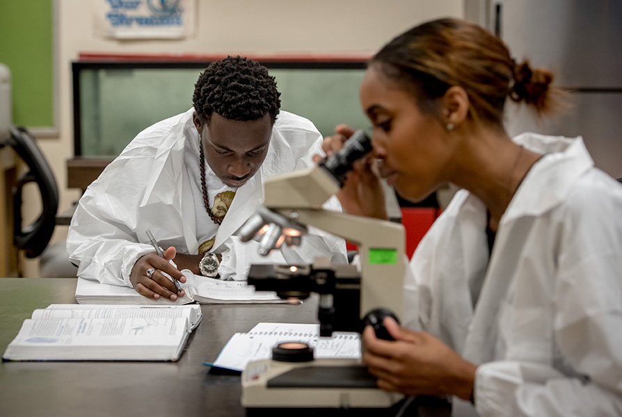 two students in a biology lab