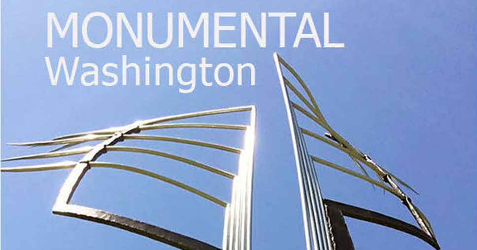 A metal sculpture against a blue sky and the words Monumental Washington.