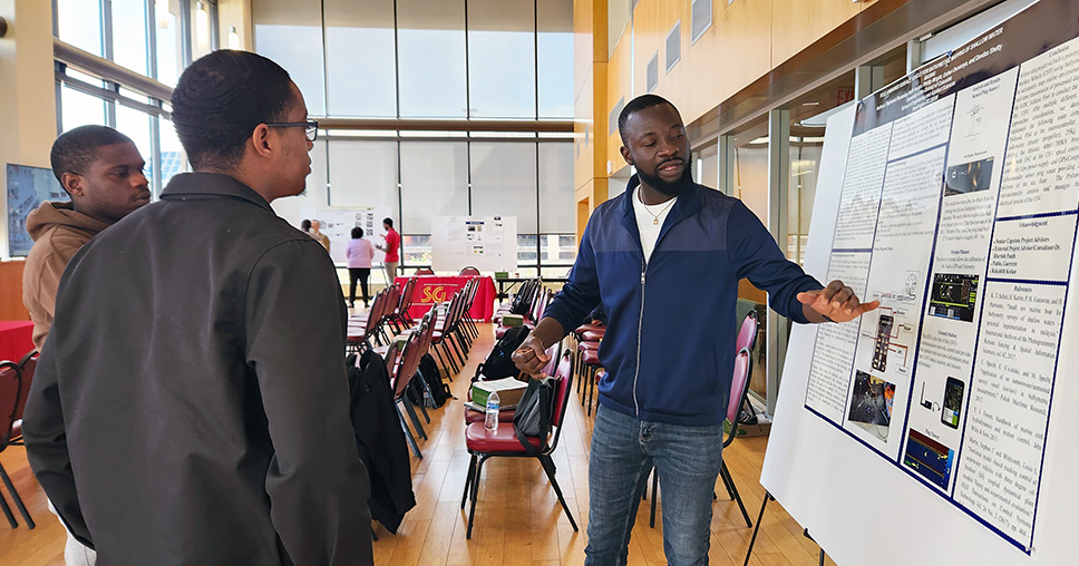 SEAS student presenting his poster at Research Week 2024