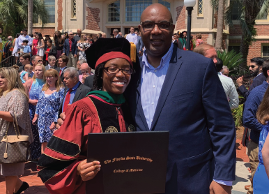 President Maurice D. Edington, Ph.D., poses with his daughter Gabby at graduation at Florida State University’s College of Medicine.