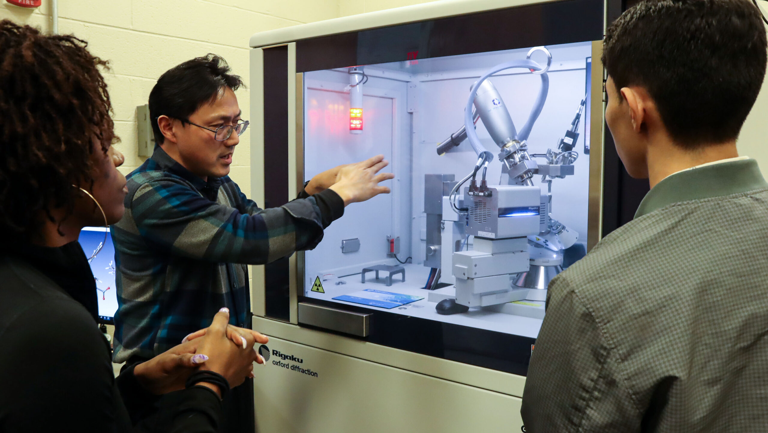 Chemistry students Nazharie Brandon (’24) and Julio Argueta (’24) with Dr. Xueqing Song